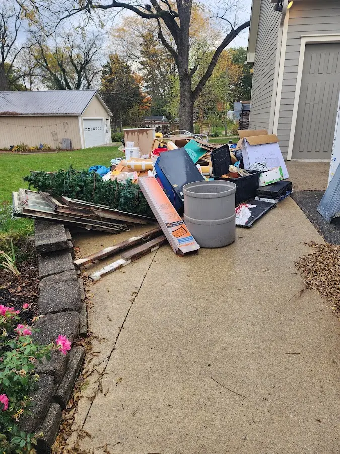 Dumpster being loaded with debris for 12 Yard Dumpster Rental in Laguna Vista